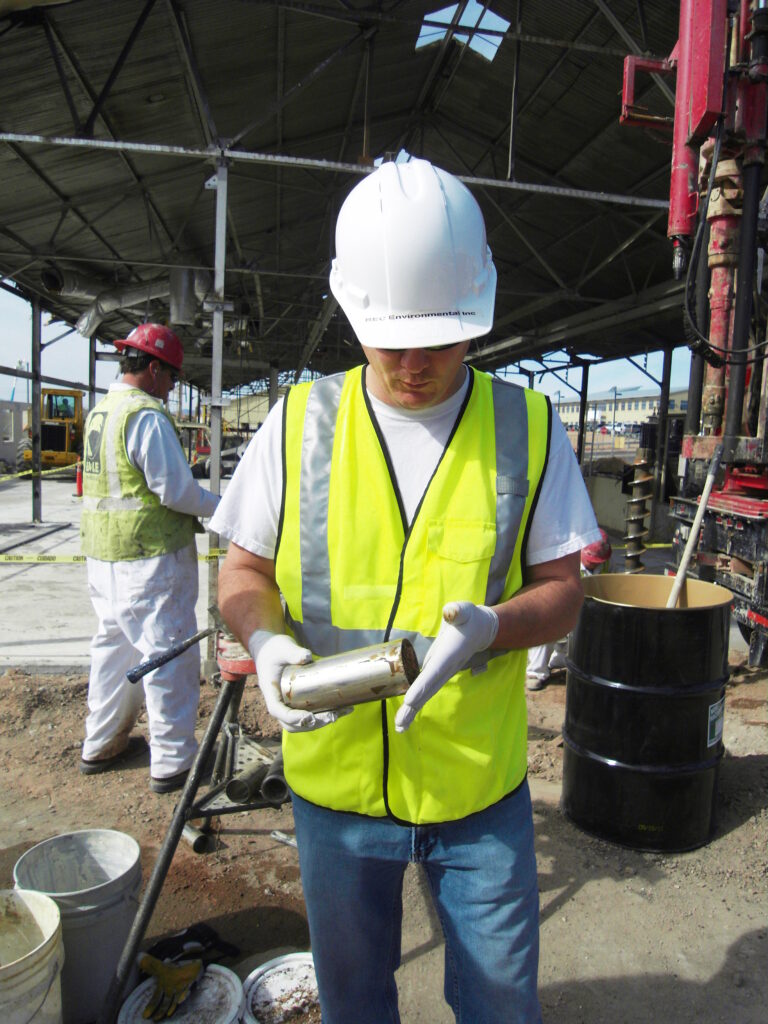 A BEC environmental scientist inspects a soil sample collected via core drilling