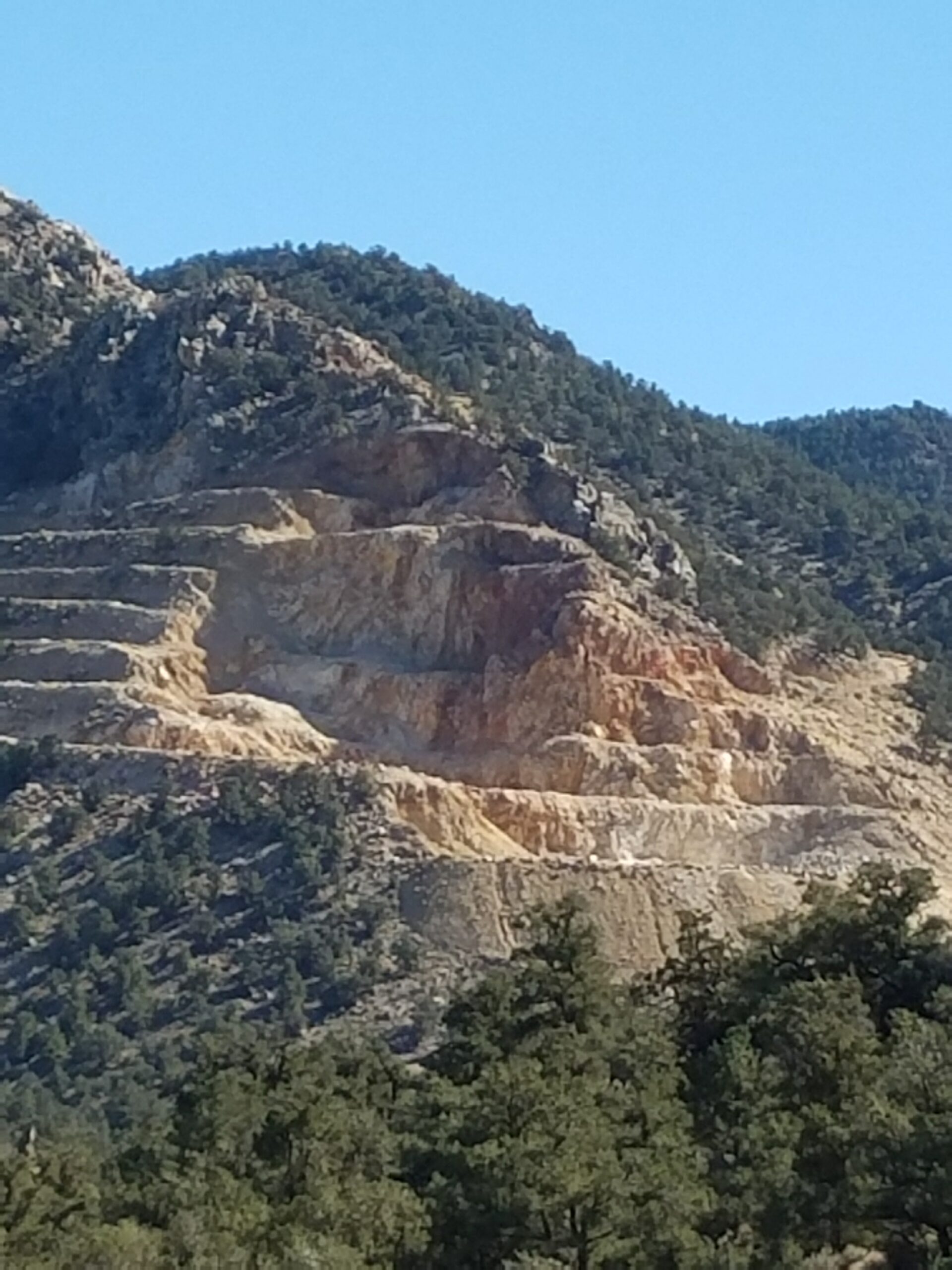 Desert mountainside with stairstep like indentations.