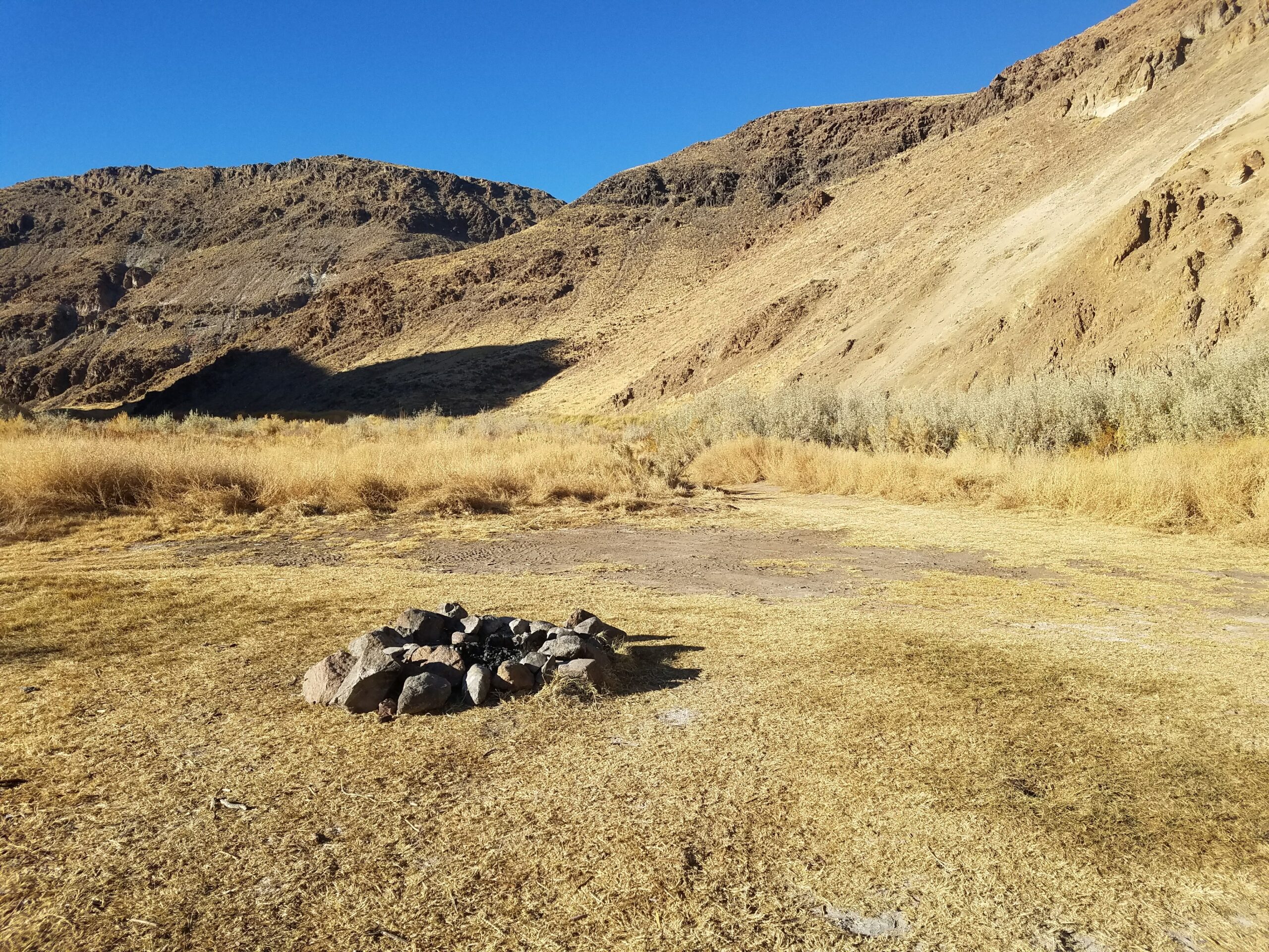 Desert grassland -Walker River State Park with firepit.